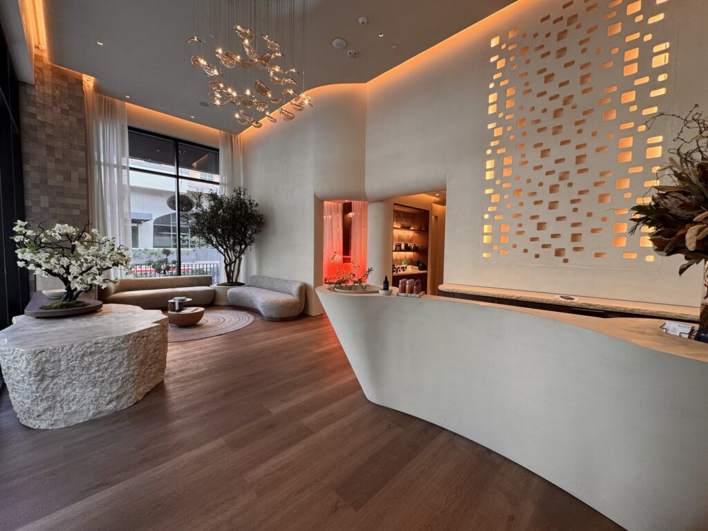 The bluSONIL studio lobby in Scottsdale with its sculptural reception desk and glowing perforated wall